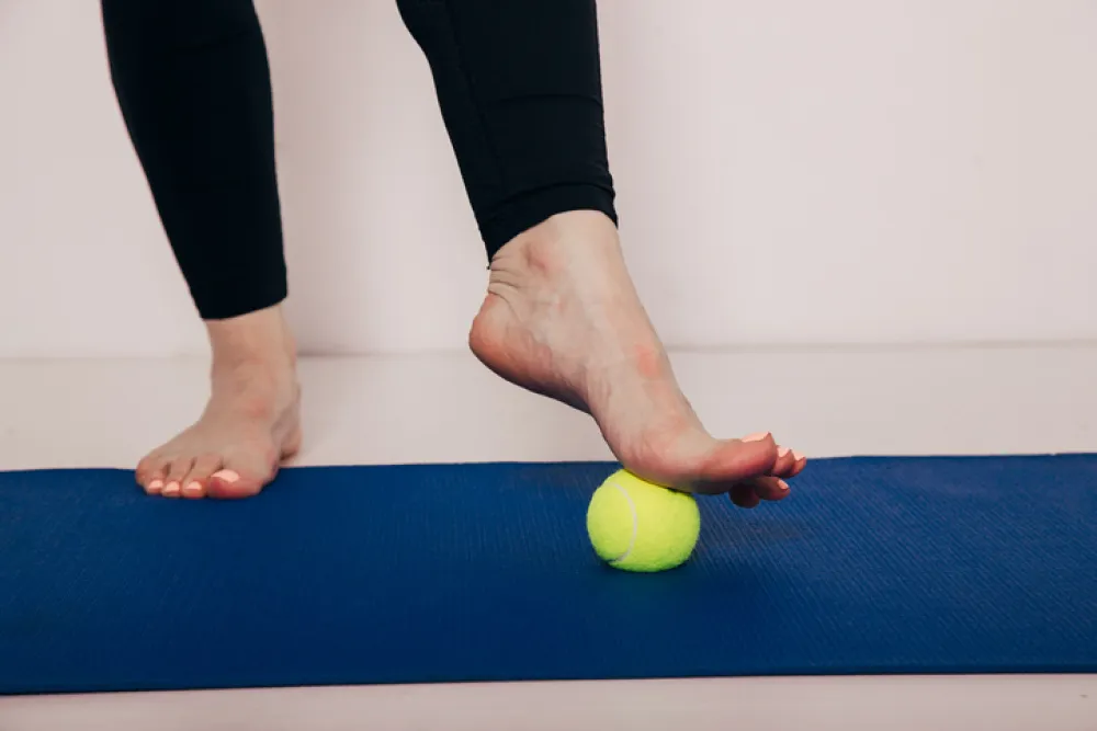 The Tennis Ball Treatment. The ball will apply pressure to the painful spot and raise the procedure. Image with copy space