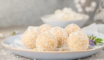 Homemade sweet white chocolate and coconut in a plate. Candy - snowball truffles on a Christmas table