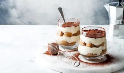 Traditional Italian dessert tiramisu in a glass. 